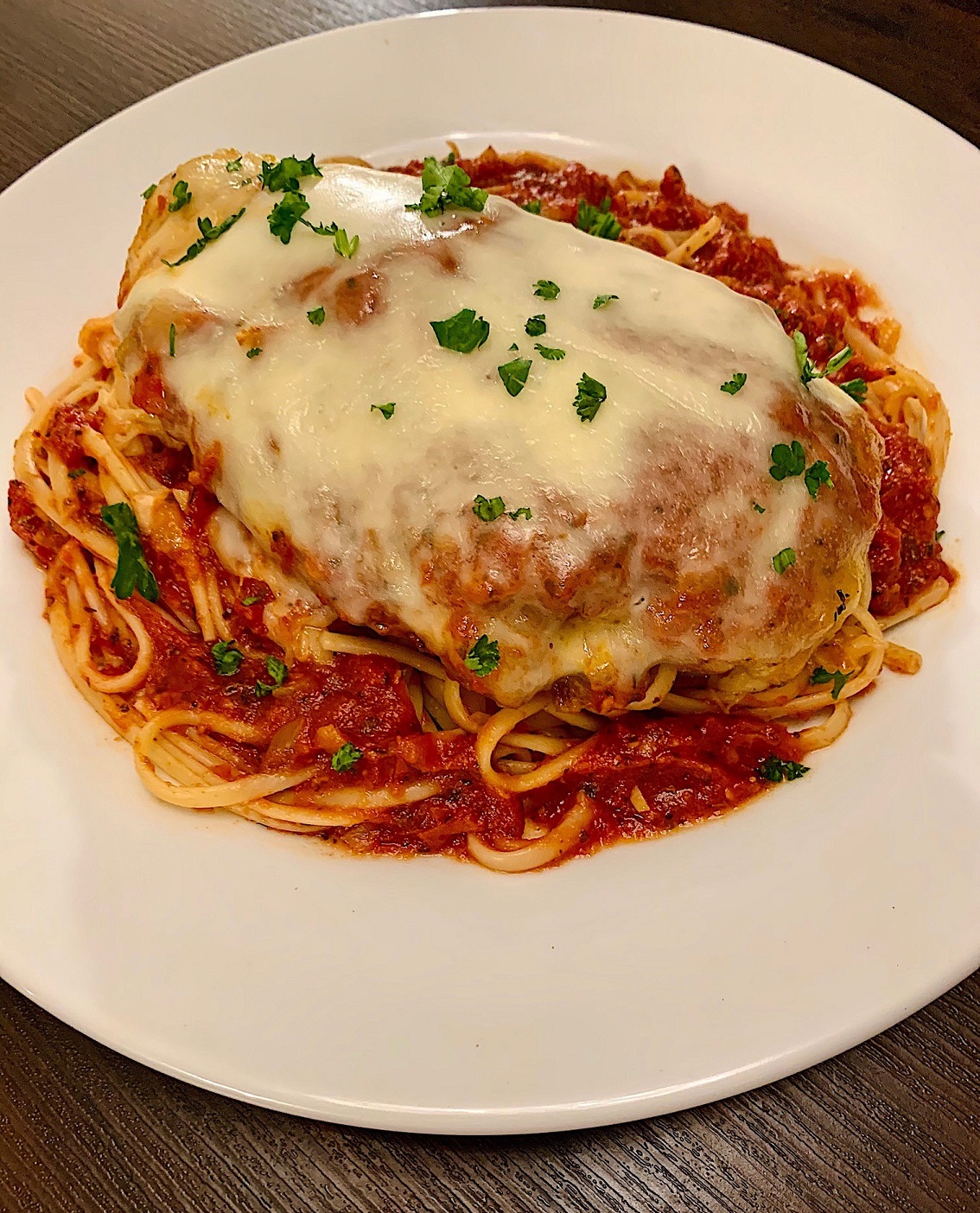 Parmesan-crusted chicken breasts, topped with fresh mozzarella, and baked in a rich marinara sauce.